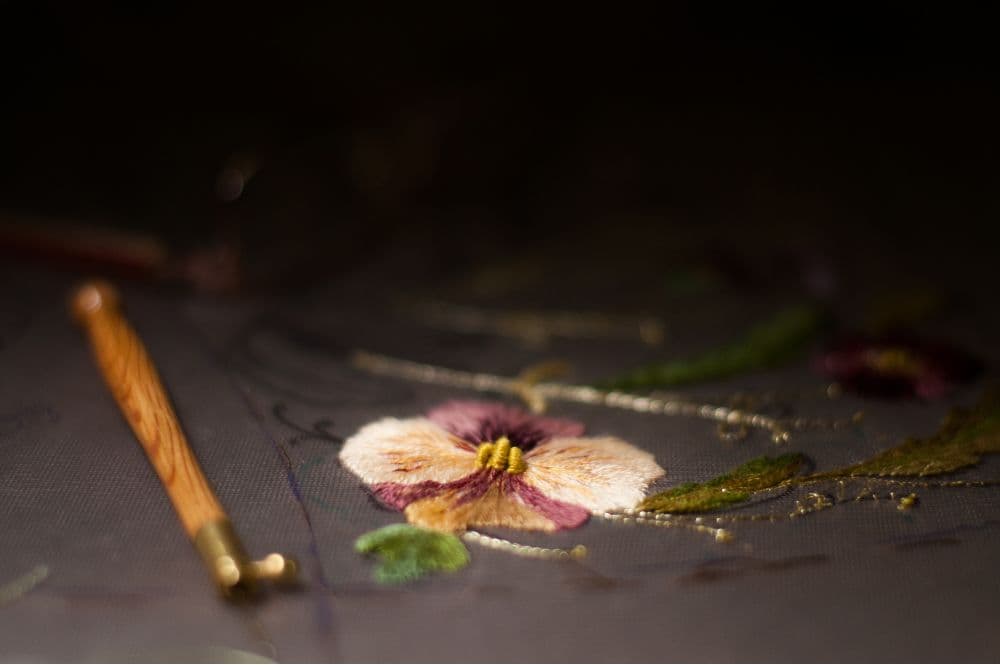 a fragment of an embroidery with violets