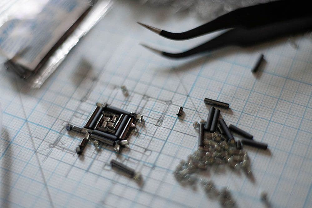 glass beads laid out on a tracing paper with design