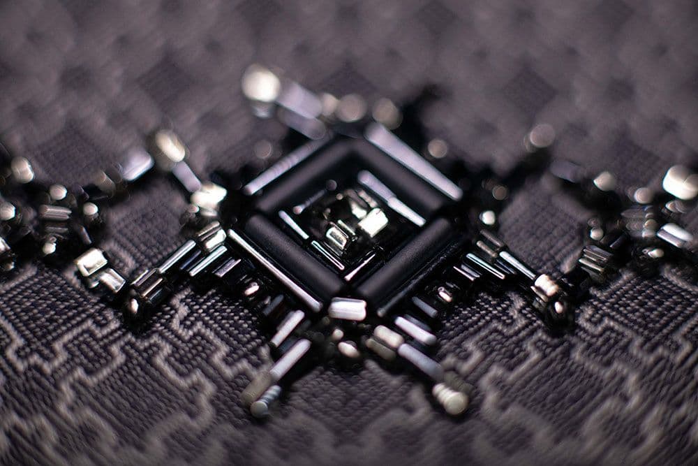 a close-up to the fitting of embroidery motif onto the fabric