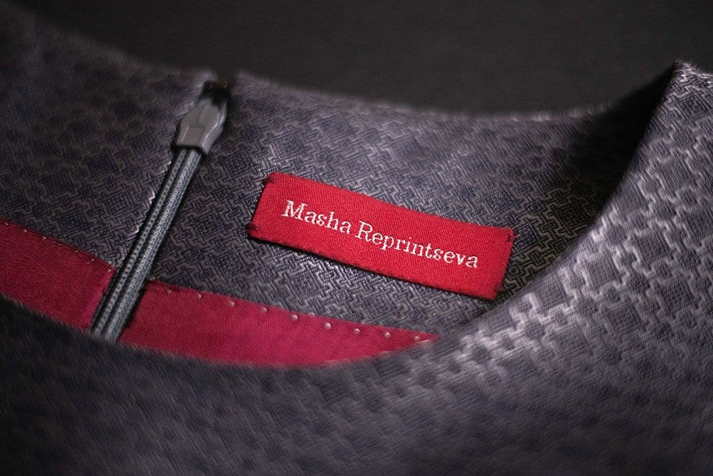 a close-up to the hand-sewn tag