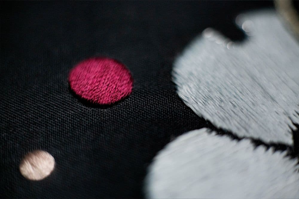 a close-up on an embroidered dogwood flower and drops of the mist .jpg