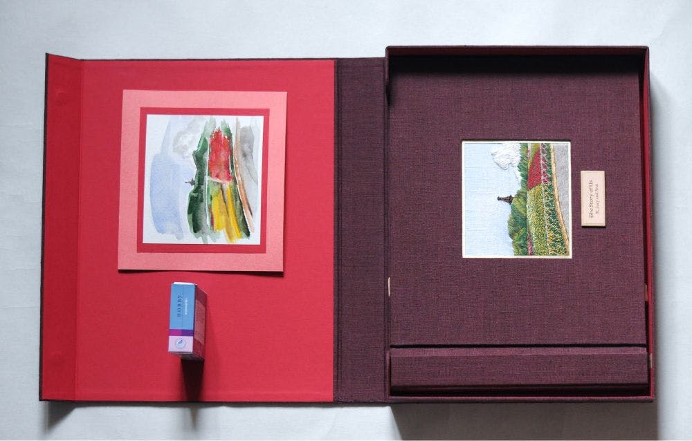 a hand-made photo album decorated with an embroidered design of a Chinese temple