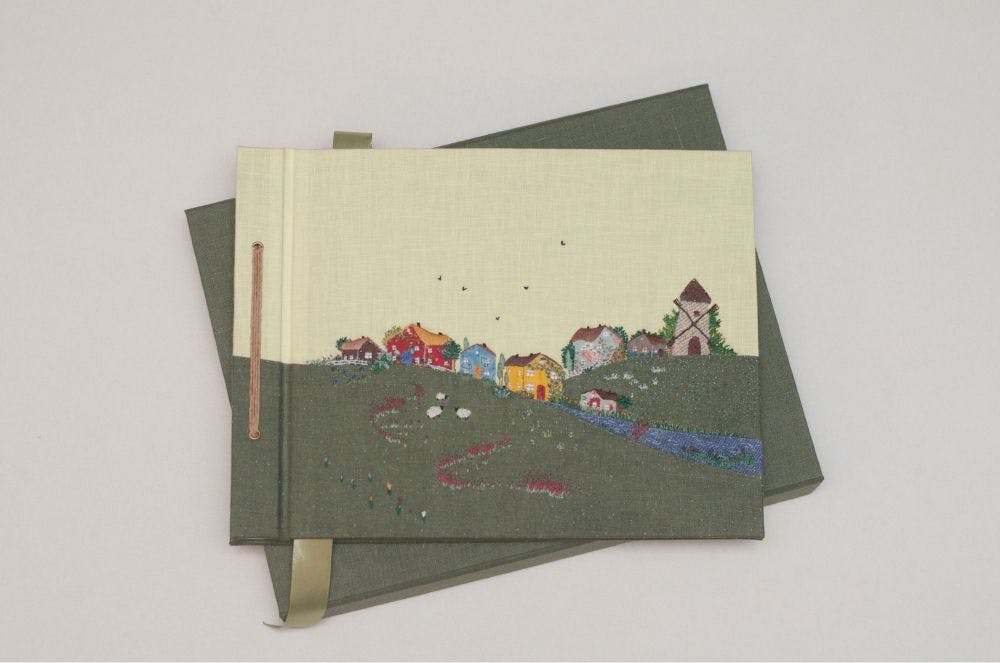 the cover of a hand-made photo album decorated with a Needle Turn Appliqué & Embroidery
