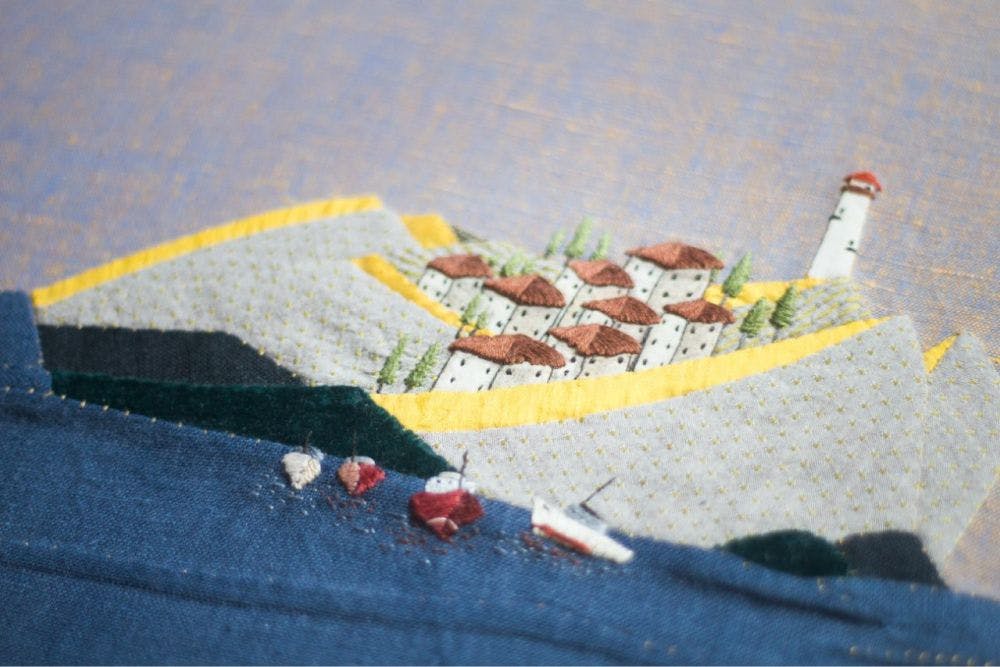 a close-up of a hand-made photo album decorated with a Needle Turn Appliqué & Embroidery