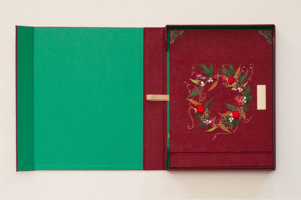 the cover of a hand-made photo album decorated with stumpwork embroidery