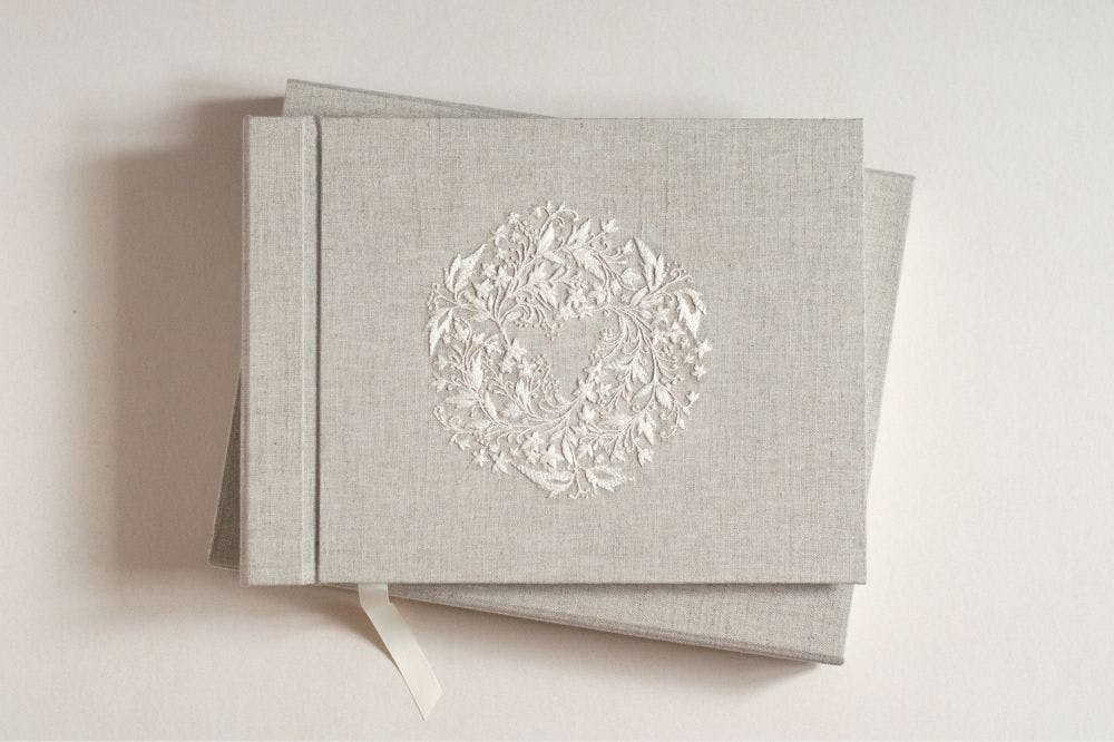 the cover of a hand-made photo album decorated with whitework made in raw silk