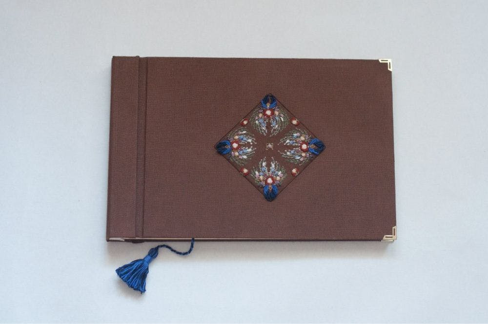 the cover of of a hand-made photo album decorated with motifs of traditional Pavlovo-Posad Shawls