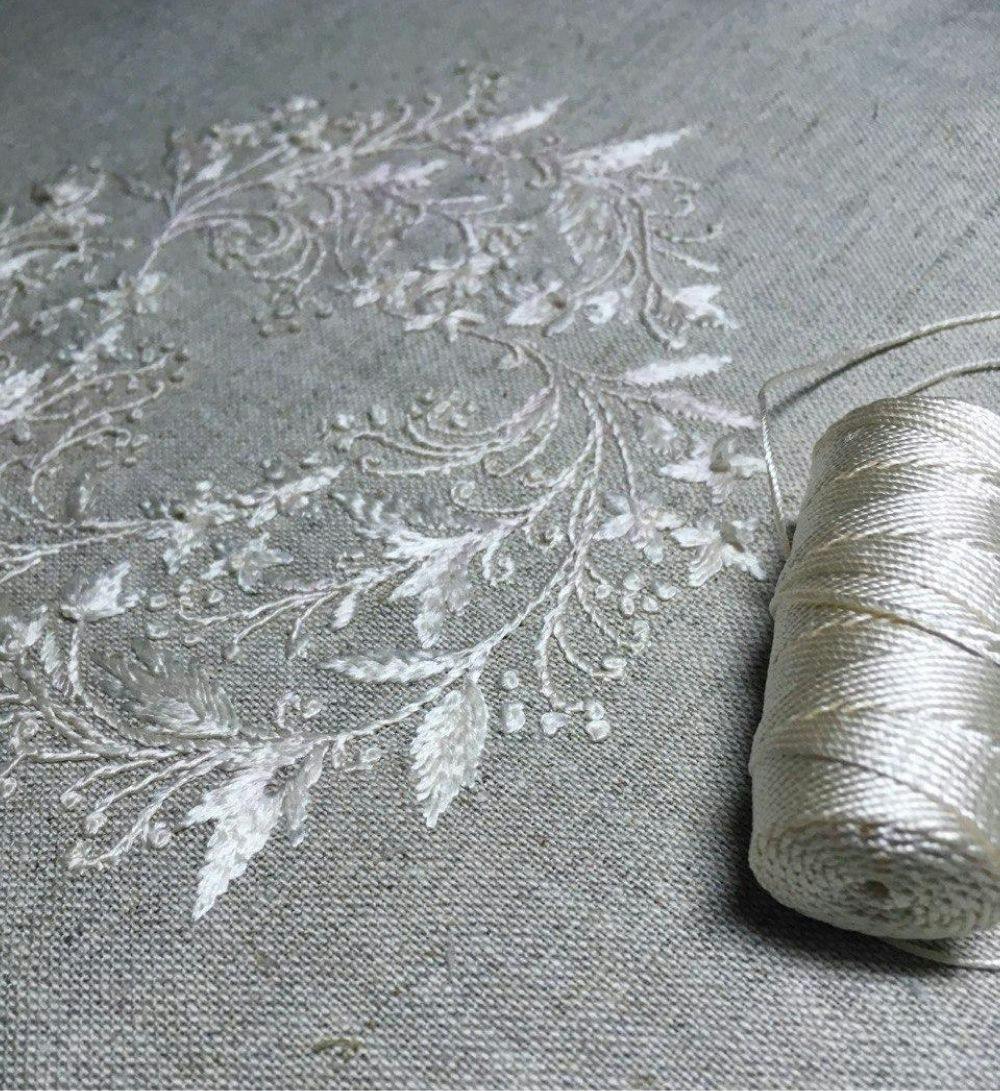 a piece of whitework embroidery made in raw silk