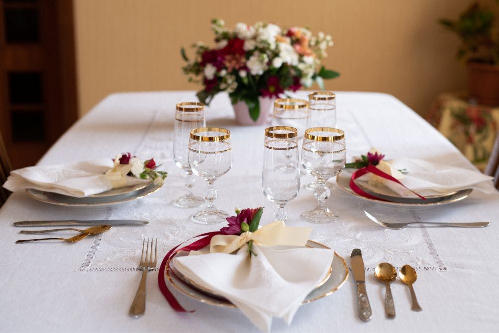 festive served table with whitework tablecloth