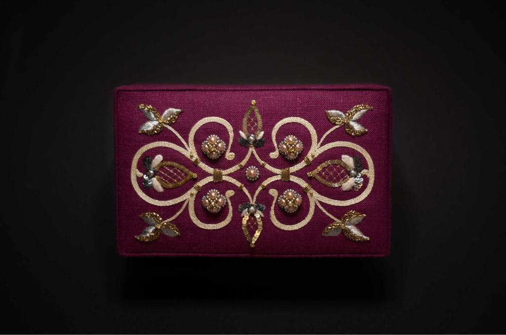 a jewllery box with embroidered cover
