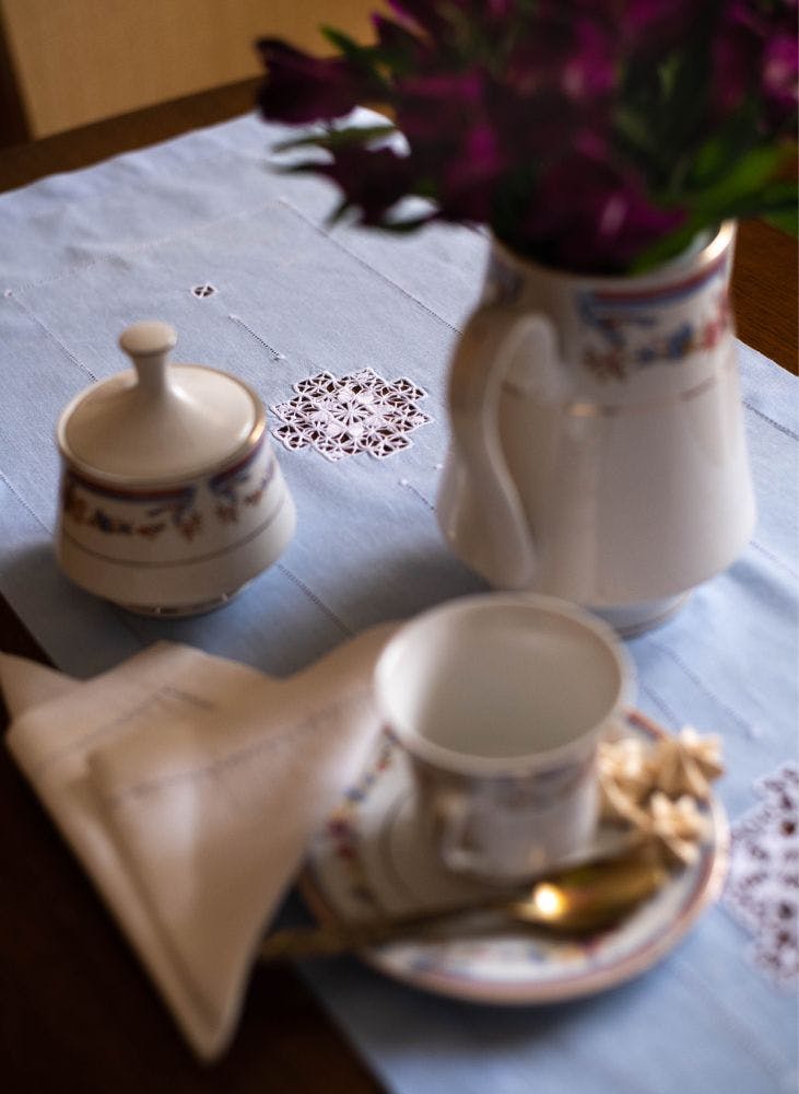 the table served with needle-lace table runner