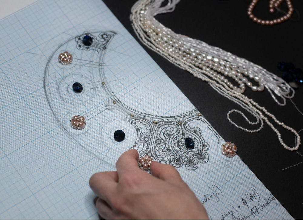 fitting the materials to the drawn embroidery pattern