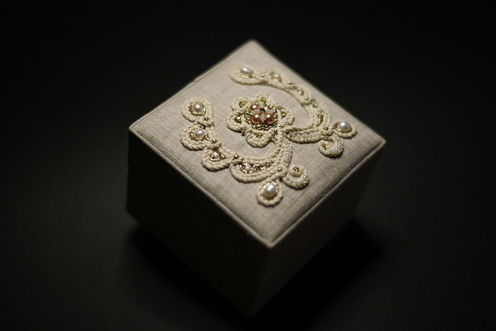 a close-up to a hand-embroidered jewellery box decorated with high relief embroidery