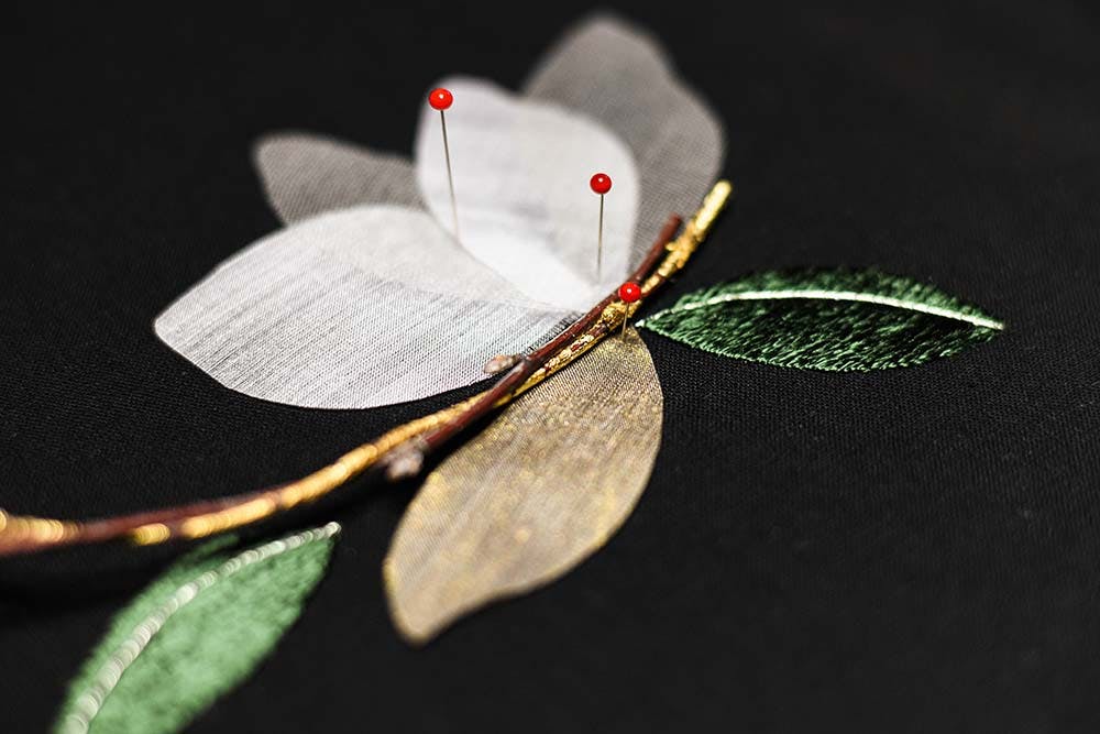 silk petals pinned to the background and arranged to be stitched 