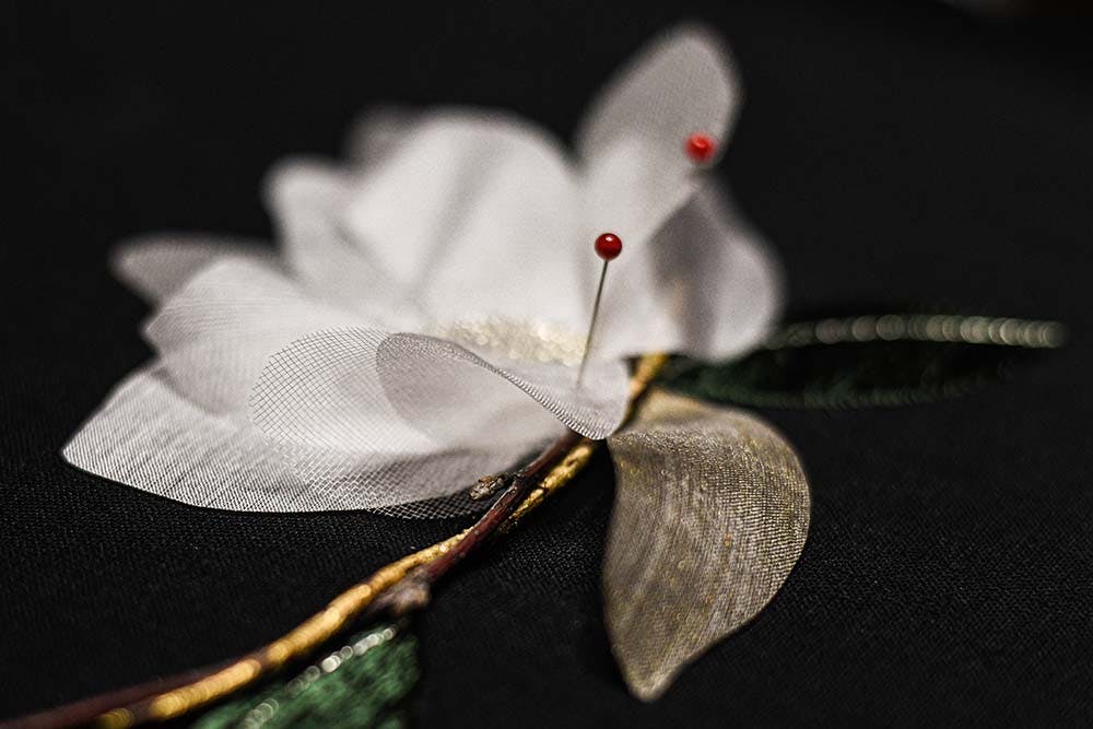 magnolia bud with pinned silk petals ready to be stitched on canvas