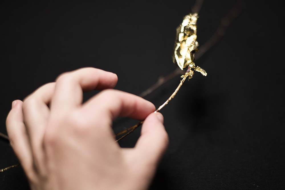 a twig with a piece of golden leaf glued onto