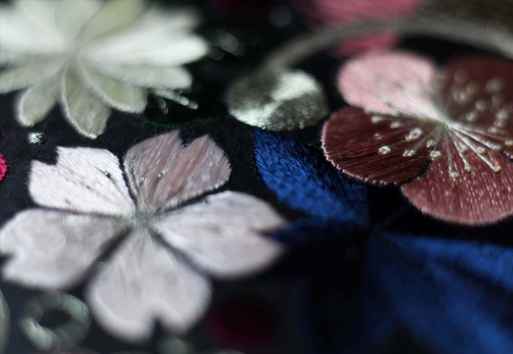 a closeup of cherry blossom embroidered with silk