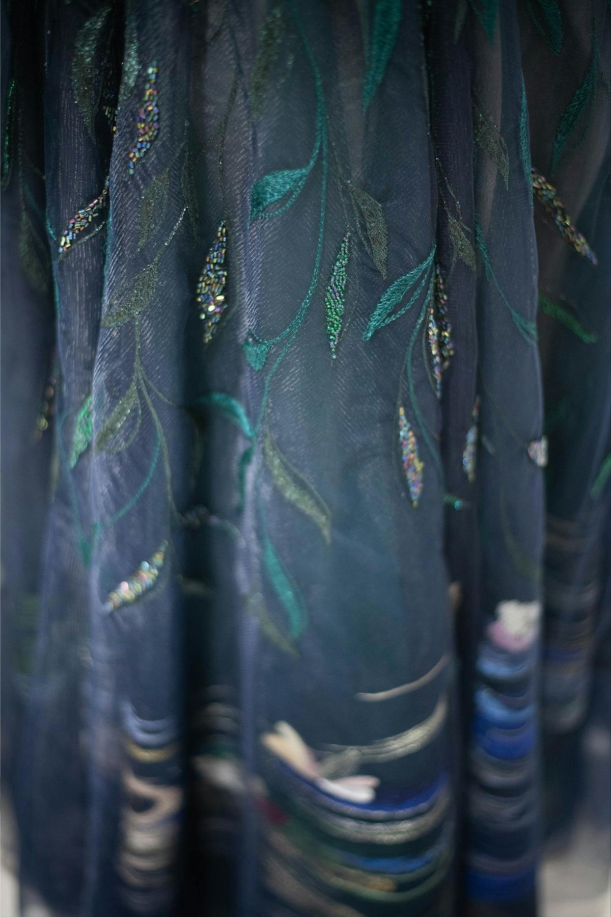 a close-up of the embroidered leaves in the skirt