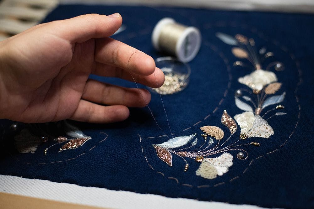 a close up to the process of carnation flowers stitching